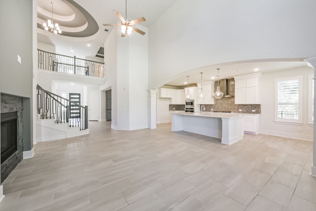 126 Keechie Creek Court Conroe, TX 77304 - Photo 19 of 50 a view of a kitchen with furniture and a fireplace