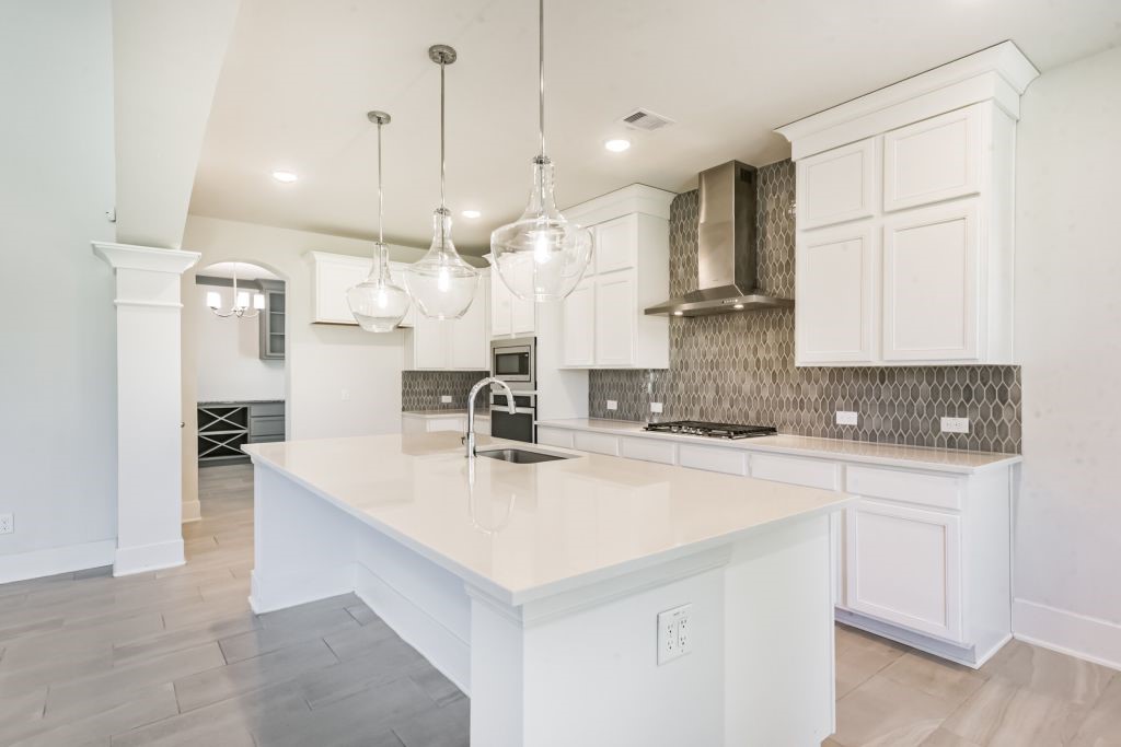 126 Keechie Creek Court Conroe, TX 77304 - Photo 22 of 50 a large kitchen with kitchen island a sink appliances and cabinets