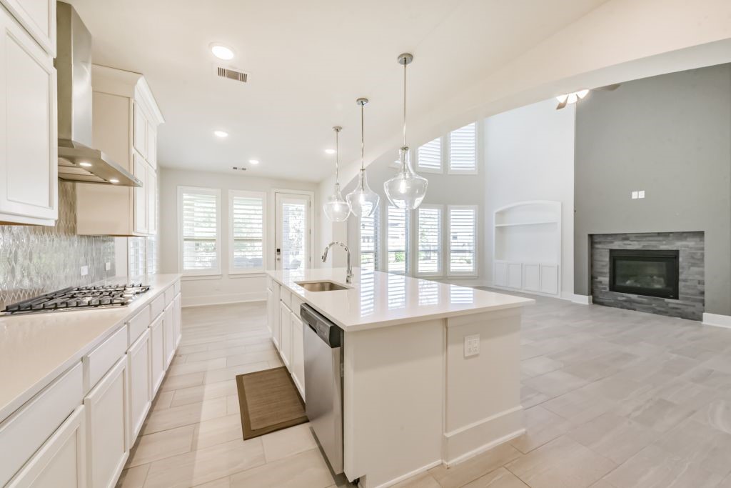 126 Keechie Creek Court Conroe, TX 77304 - Photo 24 of 50 a large white kitchen with a large window