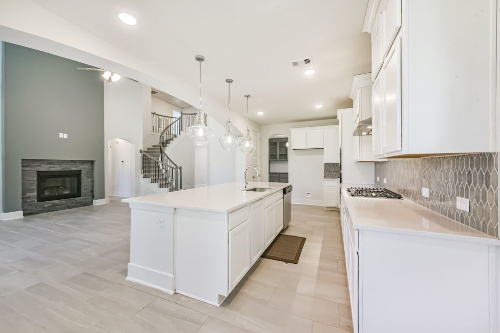 126 Keechie Creek Court Conroe, TX 77304 - Photo 27 of 50 a large white kitchen with cabinets a sink and a stove