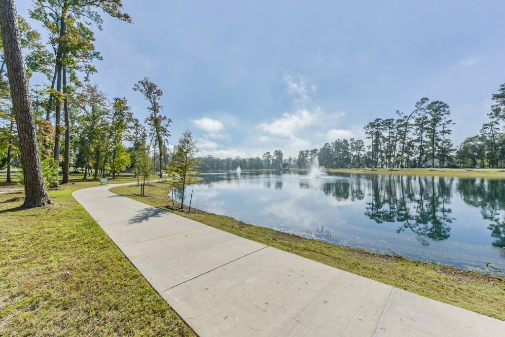 126 Keechie Creek Court Conroe, TX 77304 - Photo 3 of 50 a view of a lake with houses in the back