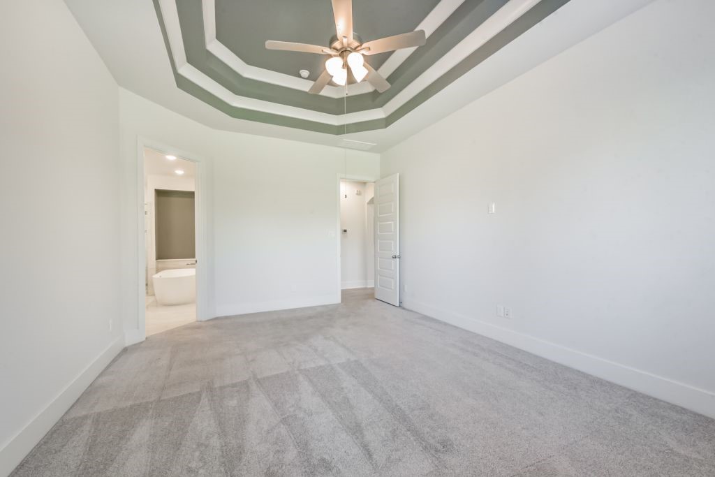 126 Keechie Creek Court Conroe, TX 77304 - Photo 33 of 50 en empty room with windows and ceiling fan