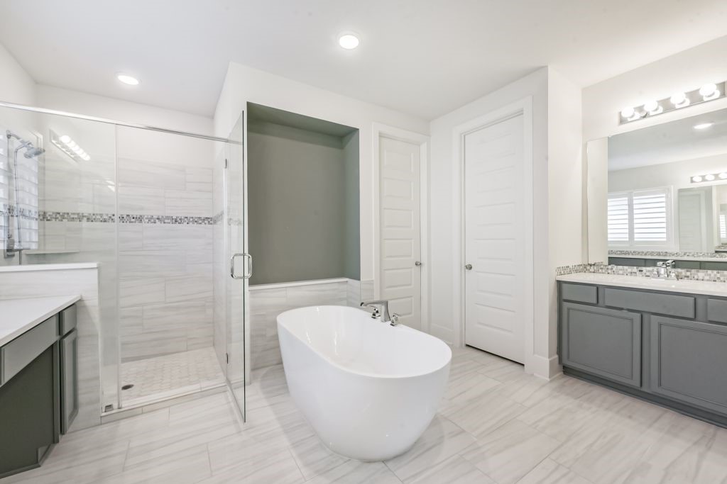126 Keechie Creek Court Conroe, TX 77304 - Photo 34 of 50 a bathroom with a bathtub and a sink