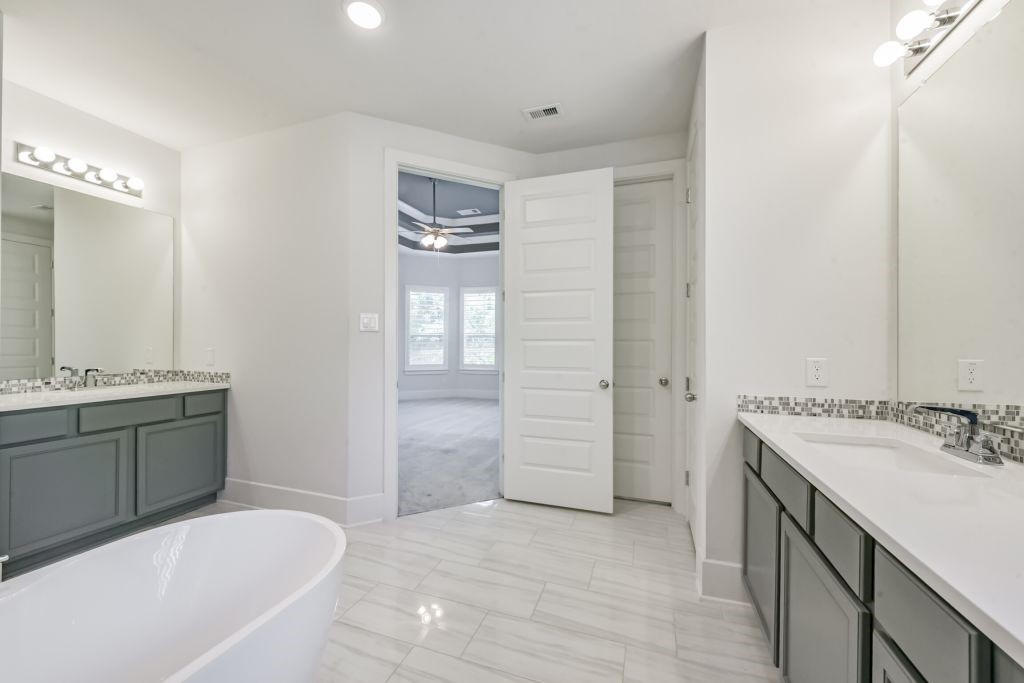 126 Keechie Creek Court Conroe, TX 77304 - Photo 36 of 50 a bathroom with a tub sink shower and mirror
