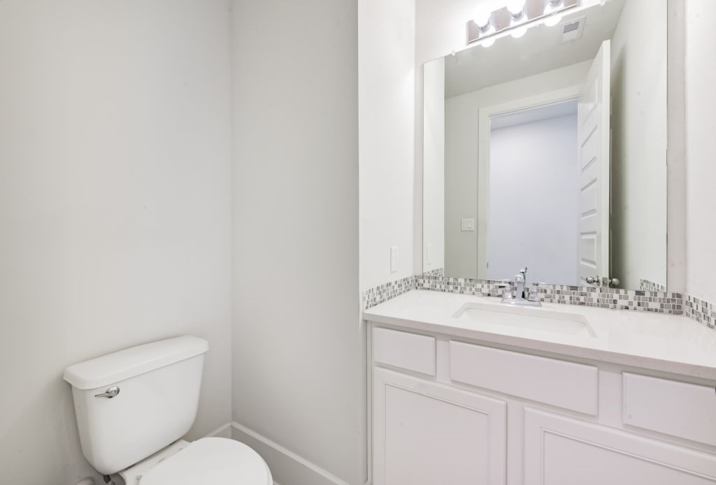 126 Keechie Creek Court Conroe, TX 77304 - Photo 39 of 50 a bathroom with a toilet sink and mirror