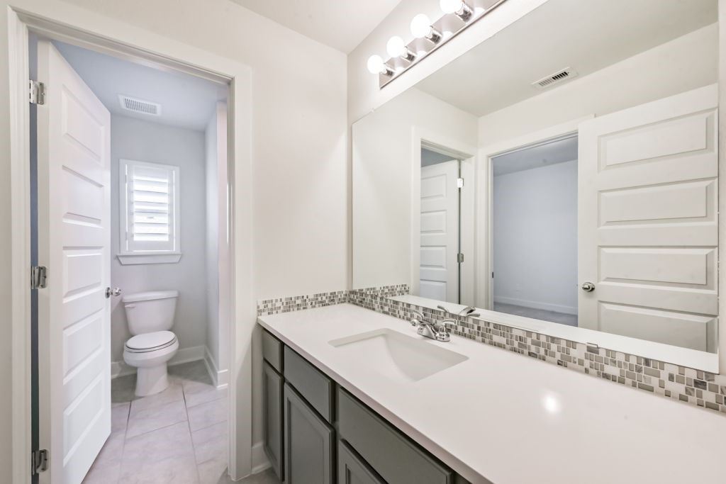 126 Keechie Creek Court Conroe, TX 77304 - Photo 47 of 50 a bathroom with a sink and a mirror