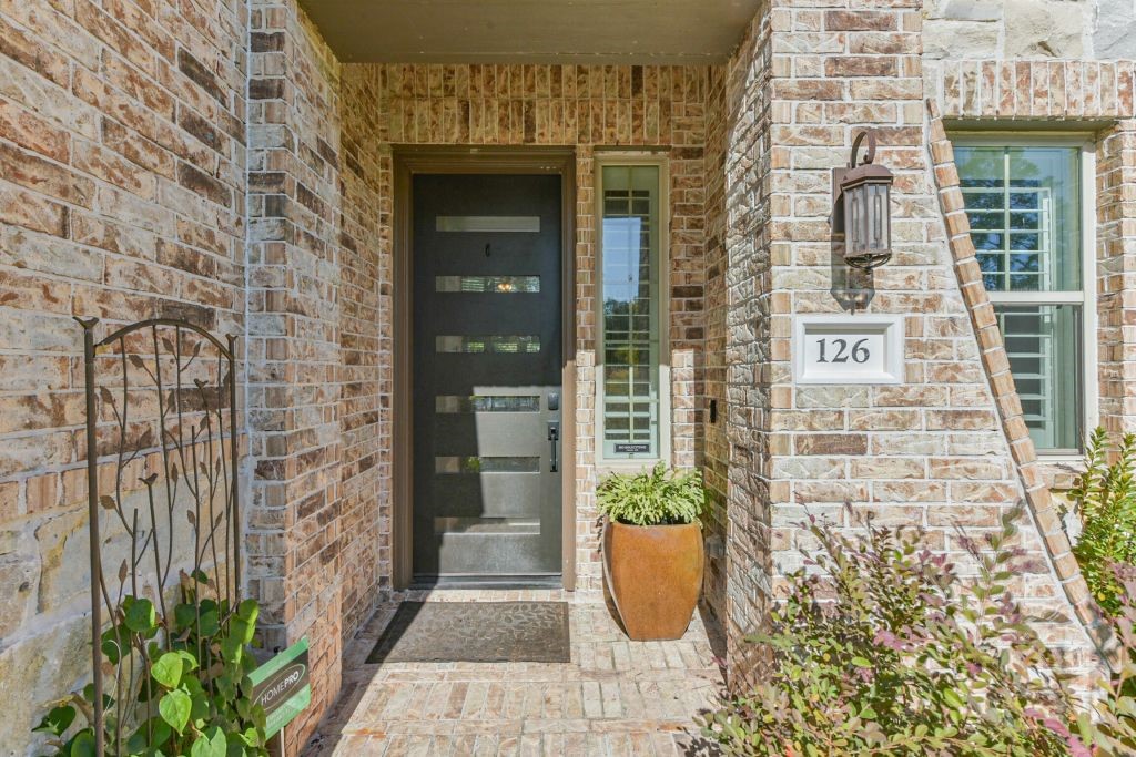 126 Keechie Creek Court Conroe, TX 77304 - Photo 8 of 50 a view of a door of the house with potted plants
