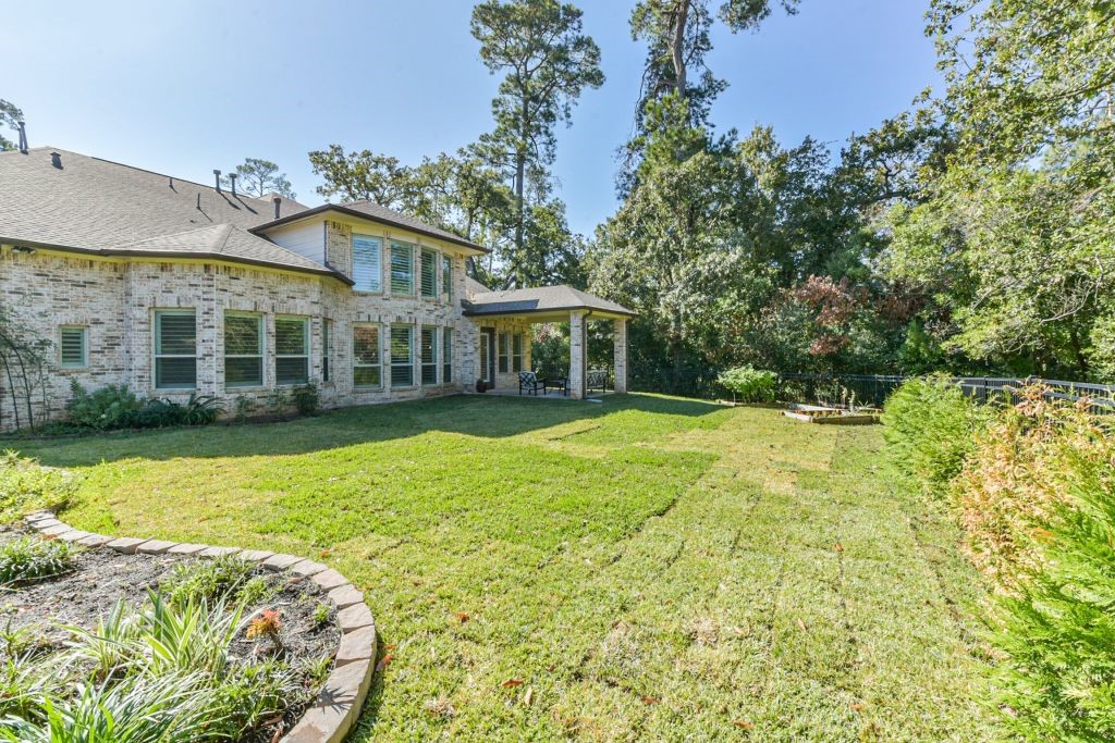 126 Keechie Creek Court Conroe, TX 77304 - Photo 10 of 50 a view of a house with a swimming pool