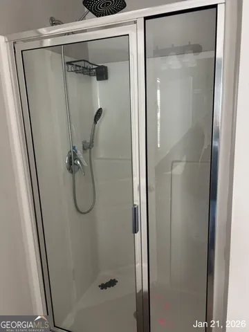 a bathroom with a glass shower door