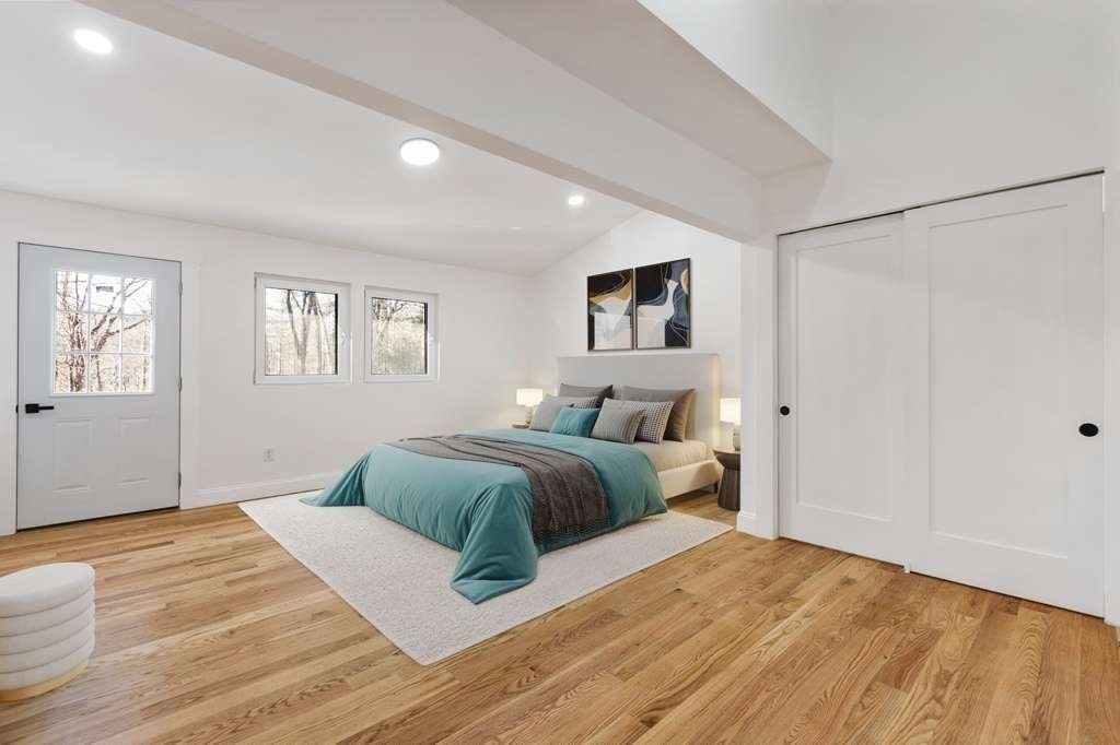 85 Jewell Street Mansfield, MA 02048 - Photo 20 of 42 a spacious bedroom with a large bed and a wooden floor