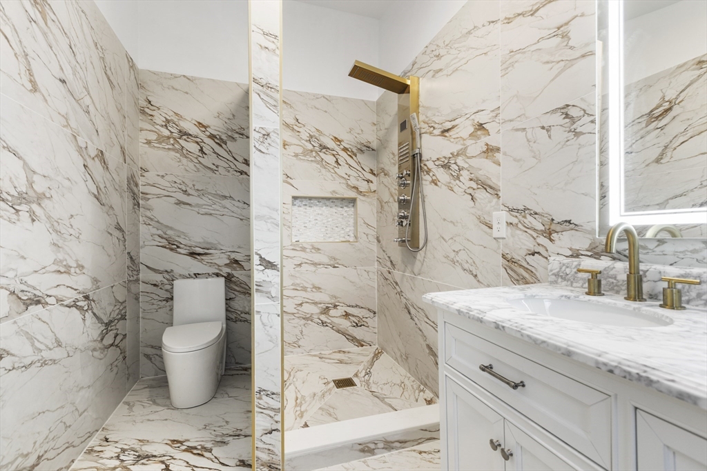 85 Jewell Street Mansfield, MA 02048 - Photo 22 of 42 a bathroom with a granite countertop sink a toilet and shower