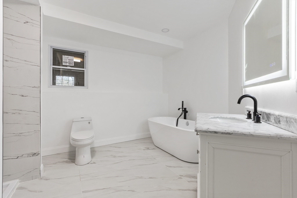85 Jewell Street Mansfield, MA 02048 - Photo 25 of 42 a bathroom with a toilet sink and mirror