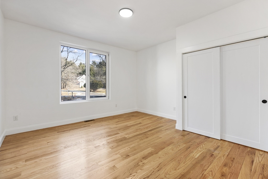 85 Jewell Street Mansfield, MA 02048 - Photo 28 of 42 a view of an empty room with wooden floor and a window