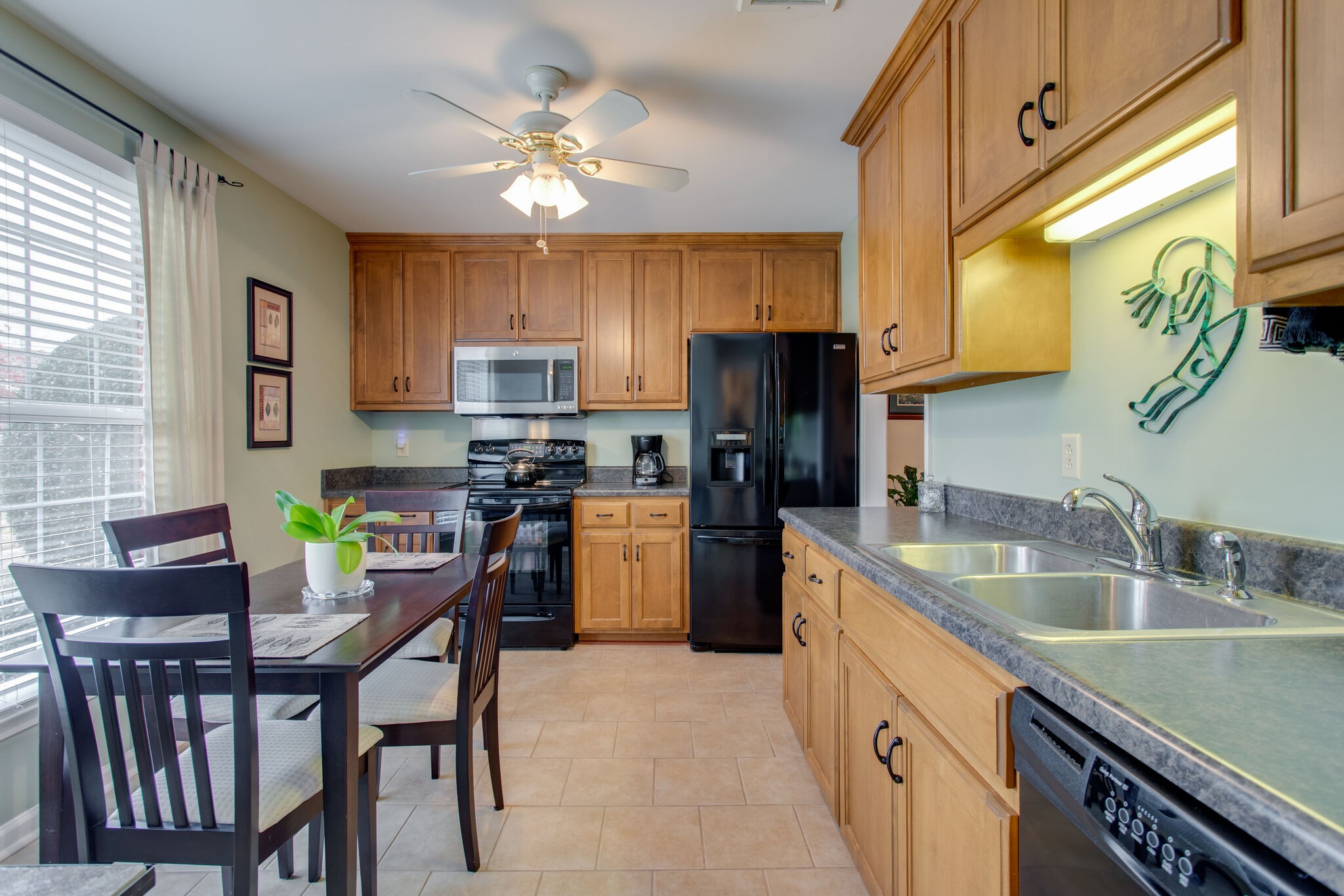 1006 General George Patton Road Nashville, TN 37221 - Photo 29 of 29 a kitchen with a sink a kitchen island a stove a refrigerator cabinets and a dining table