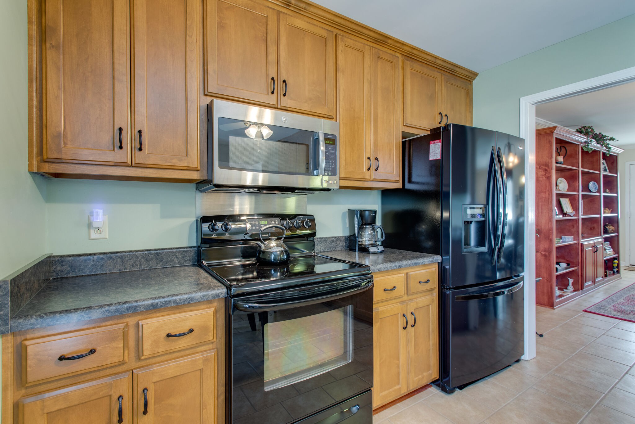 1006 General George Patton Road Nashville, TN 37221 - Photo 5 of 29 a kitchen with stainless steel appliances granite countertop a stove a refrigerator and a microwave