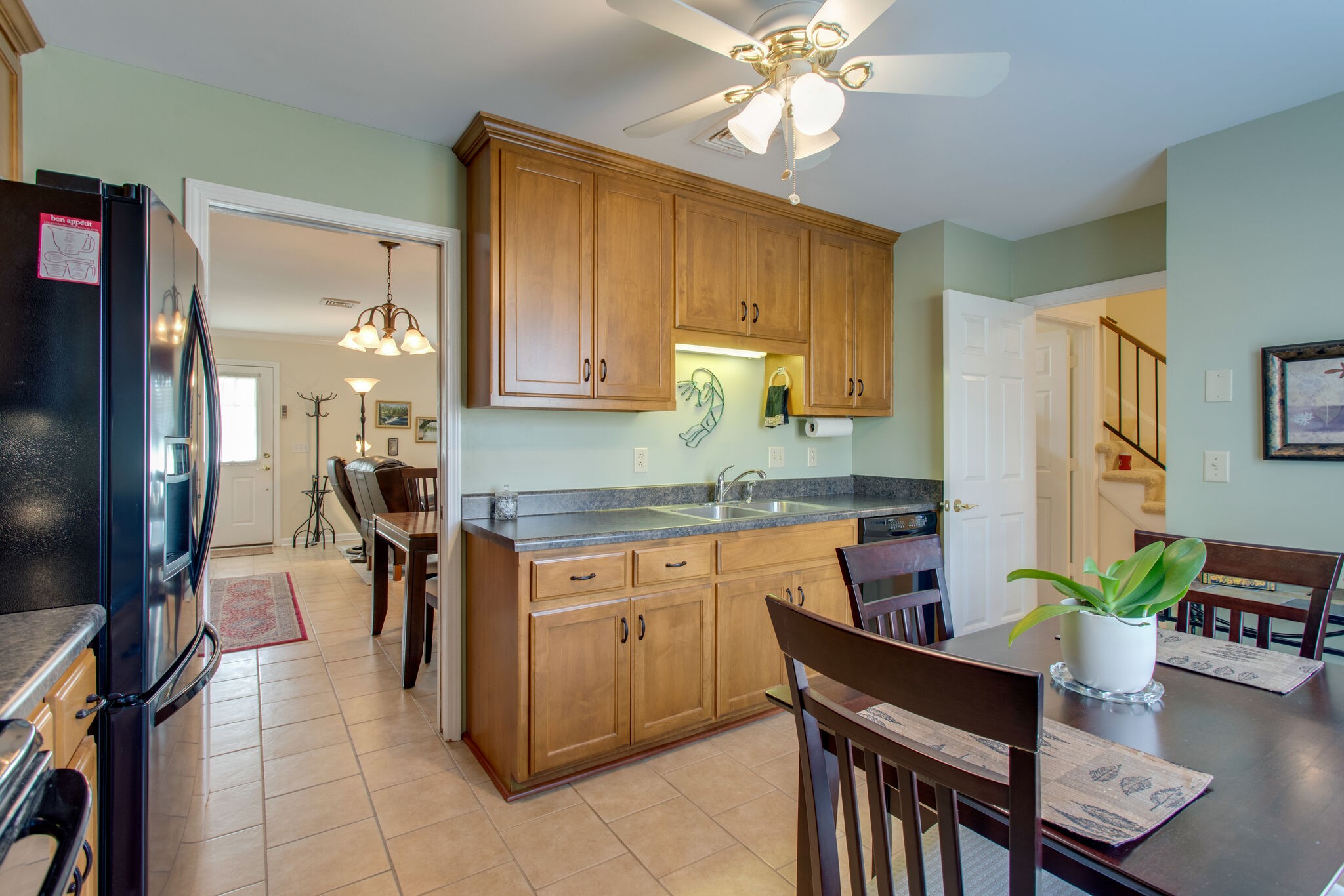1006 General George Patton Road Nashville, TN 37221 - Photo 6 of 29 a kitchen with a table chairs refrigerator and cabinets