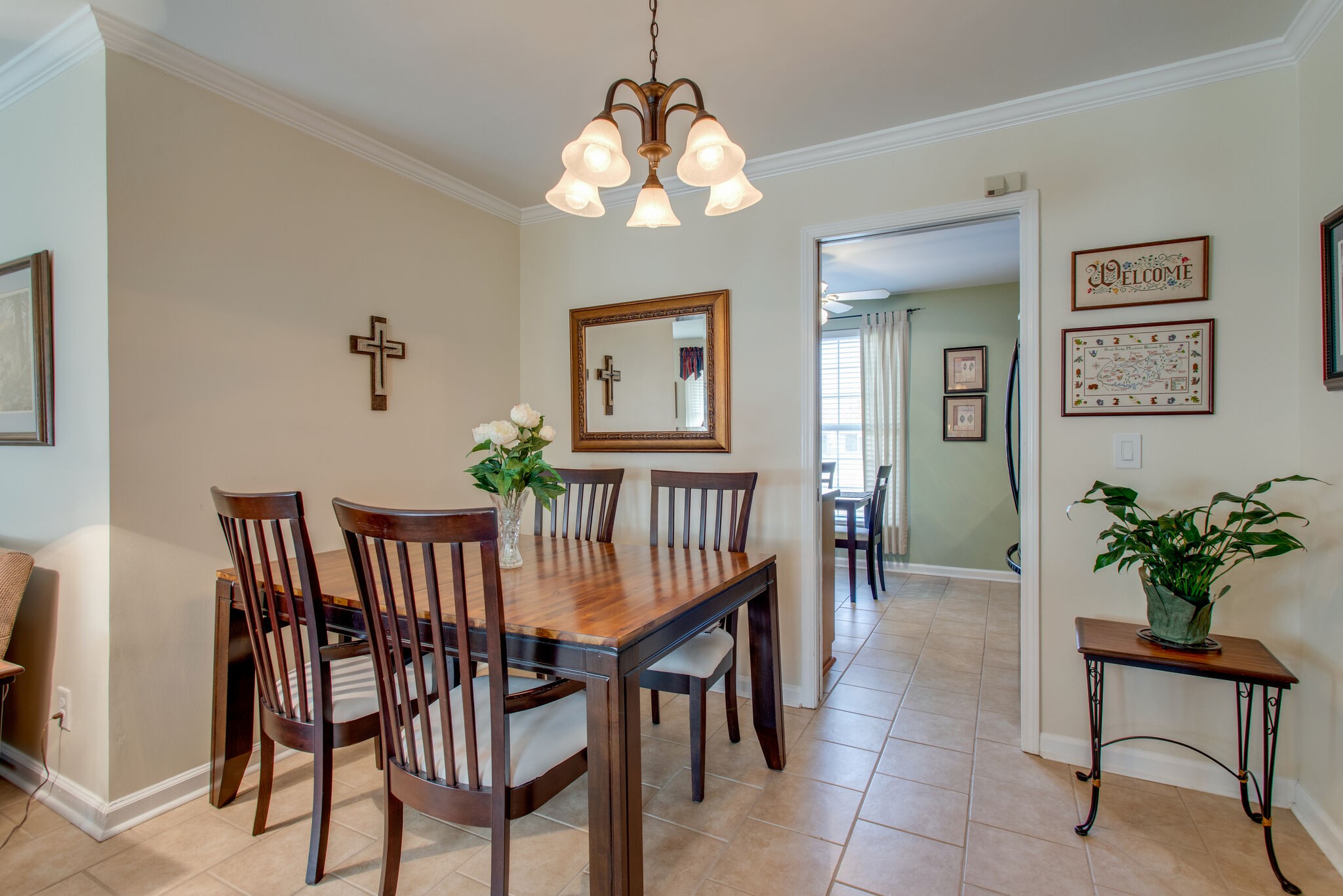 1006 General George Patton Road Nashville, TN 37221 - Photo 7 of 29 a dining room with wooden floor a chandelier a wooden table and chairs