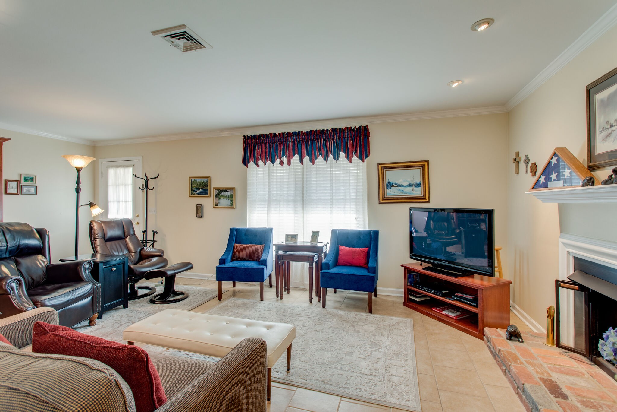 1006 General George Patton Road Nashville, TN 37221 - Photo 10 of 29 a living room with furniture a flat screen tv and gym equipment