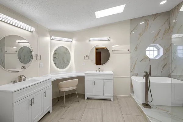 a spacious bathroom with a double vanity sink and a mirror