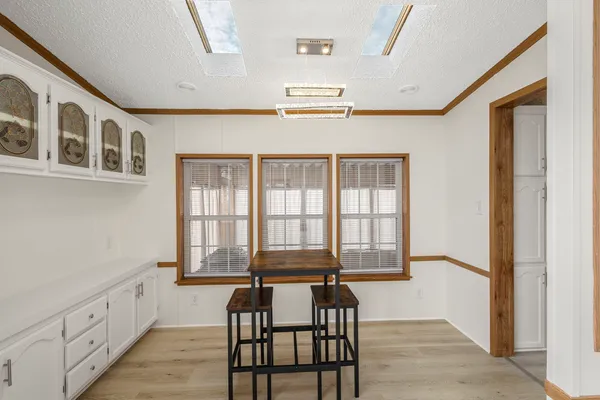 a view of a room with wooden floor and windows