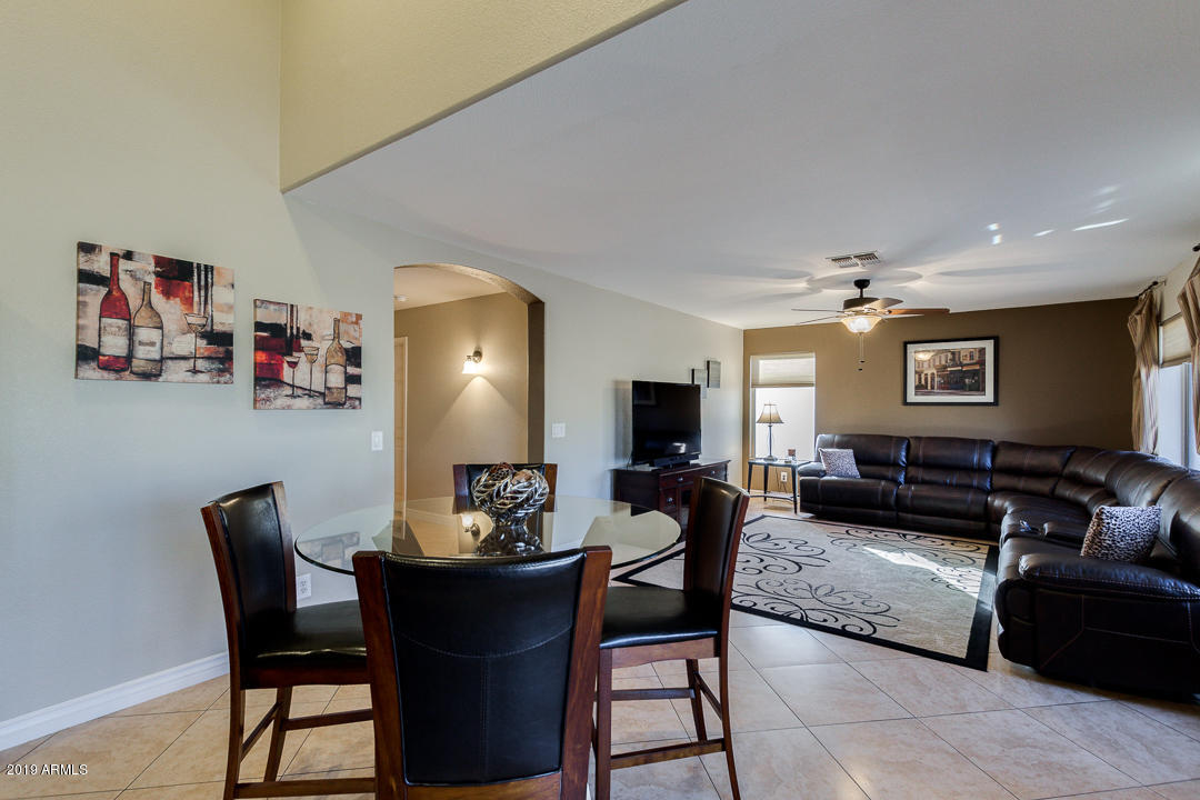 7020 West Phelps Road Peoria, AZ 85382 - Photo 10 of 35 Eat-in Kitchen Open to Family Room