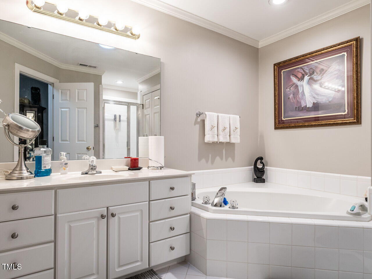 4203 Norman Ridge Lane Raleigh, NC 27613 - Photo 11 of 15 a bathroom with a tub a sink and mirror