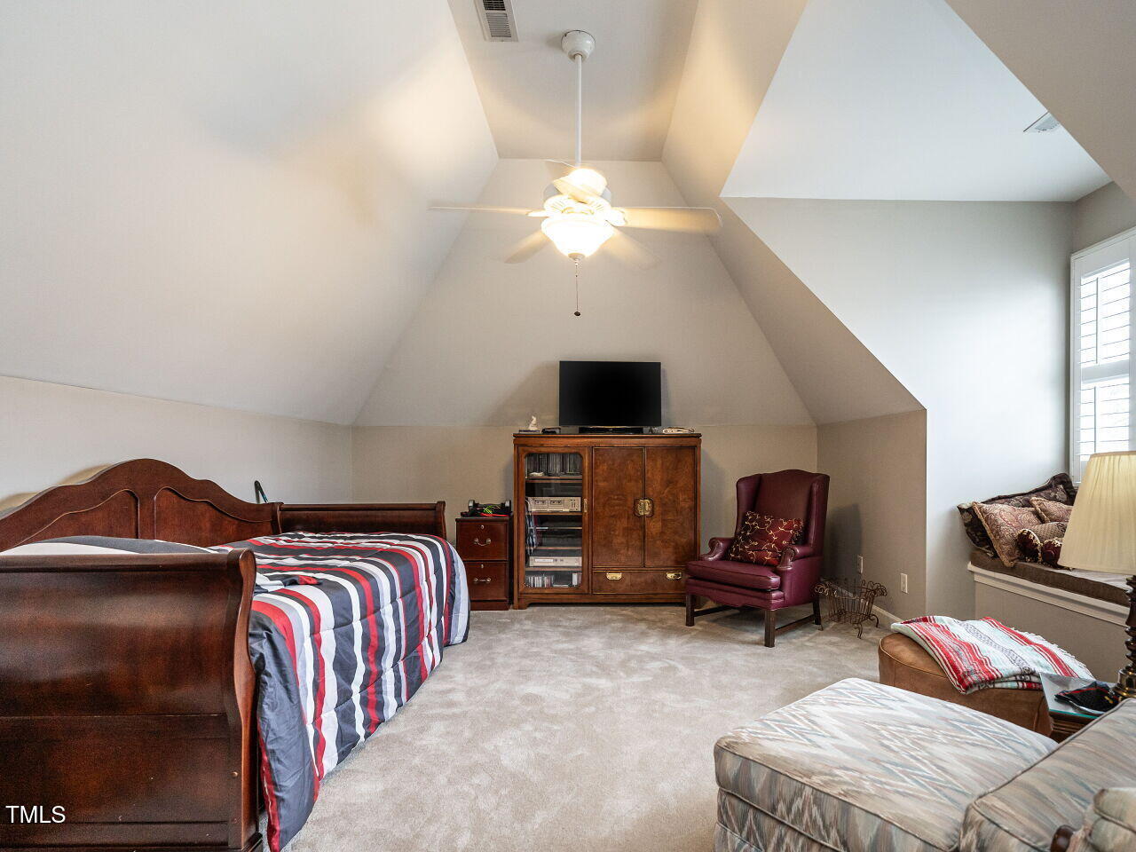 4203 Norman Ridge Lane Raleigh, NC 27613 - Photo 13 of 15 a bedroom with a bed and a chandelier