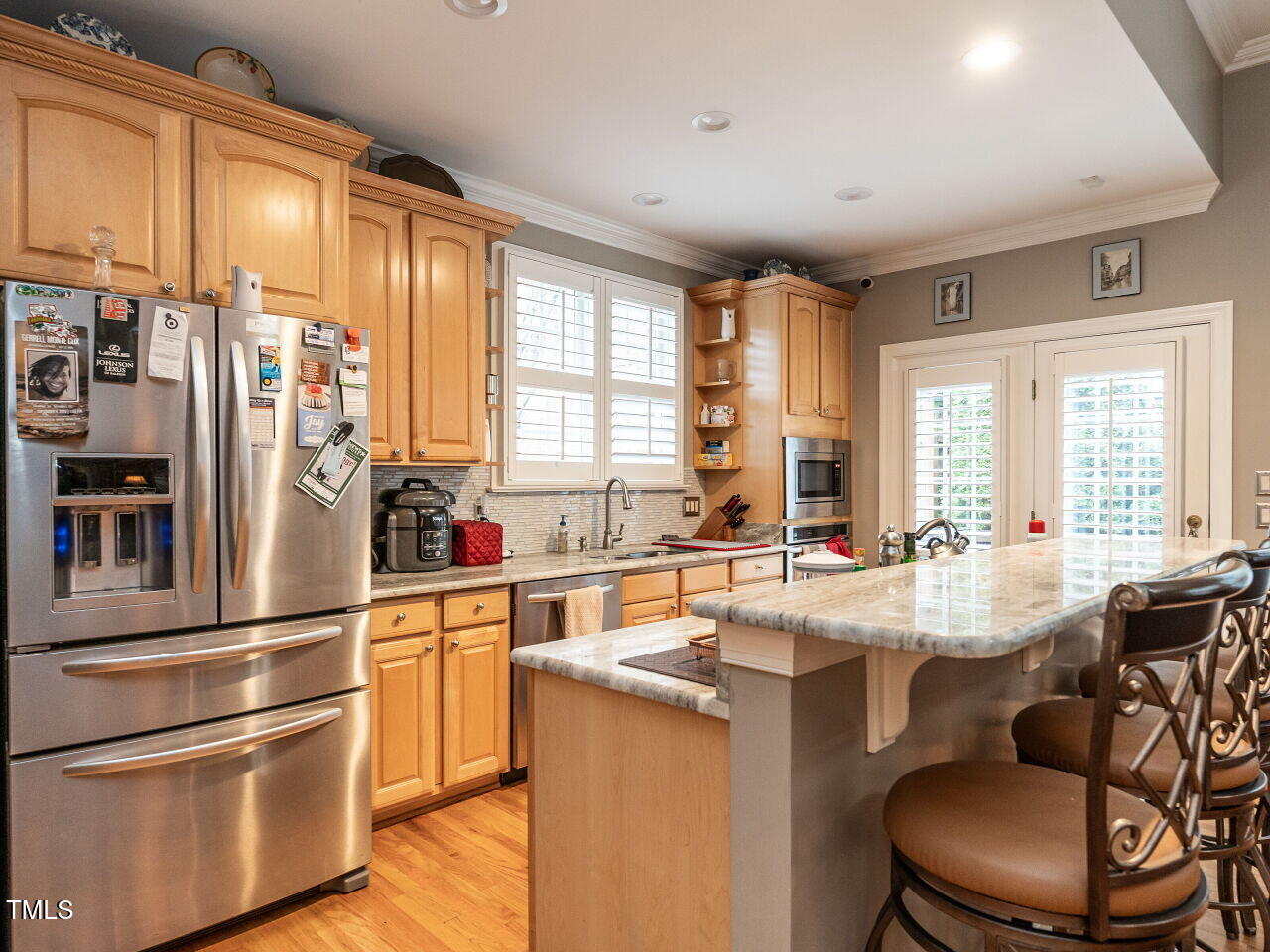 4203 Norman Ridge Lane Raleigh, NC 27613 - Photo 6 of 15 a kitchen with stainless steel appliances granite countertop a refrigerator and a stove