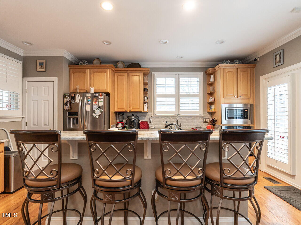 4203 Norman Ridge Lane Raleigh, NC 27613 - Photo 7 of 15 a kitchen with stainless steel appliances a table and chairs in it