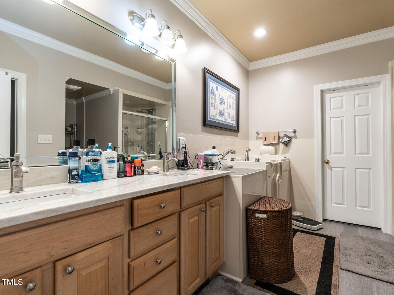 4203 Norman Ridge Lane Raleigh, NC 27613 - Photo 10 of 15 a bathroom with double vanity sink a mirror and a shower