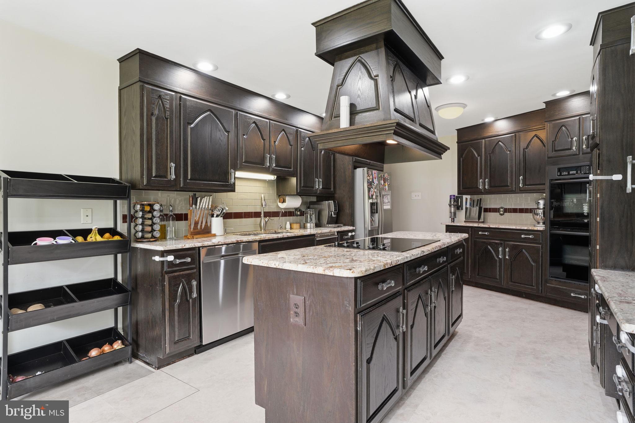 448 Moredon Road Huntingdon Valley, PA 19006 - Photo 11 of 66 a kitchen with stainless steel appliances granite countertop a stove and a sink