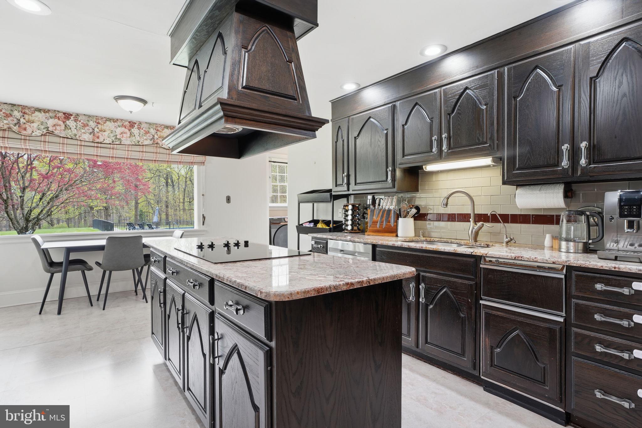 448 Moredon Road Huntingdon Valley, PA 19006 - Photo 15 of 66 a kitchen with stainless steel appliances granite countertop a sink a stove and a wooden floors