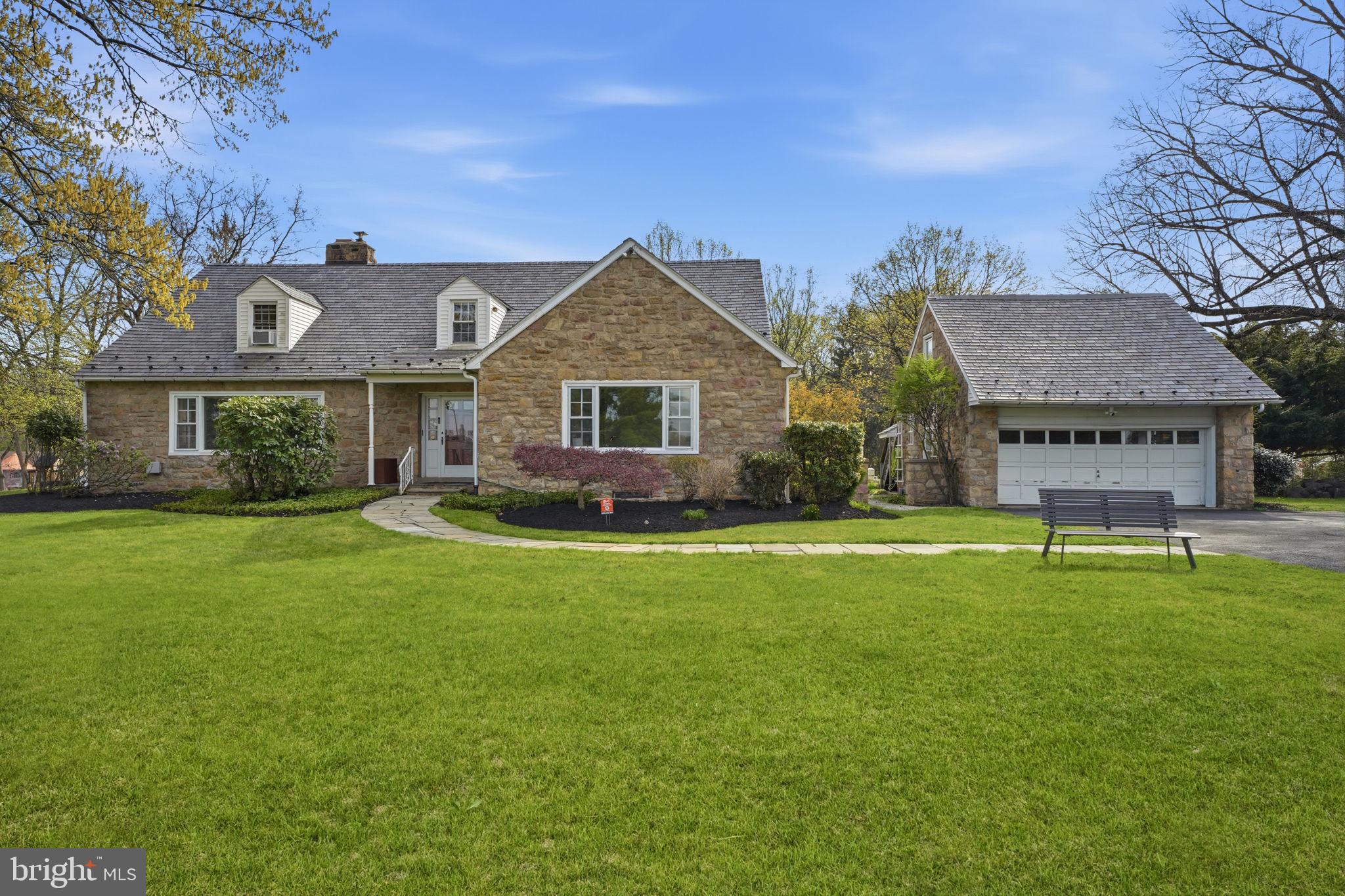 448 Moredon Road Huntingdon Valley, PA 19006 - Photo 63 of 66 a front view of a house with a garden and porch