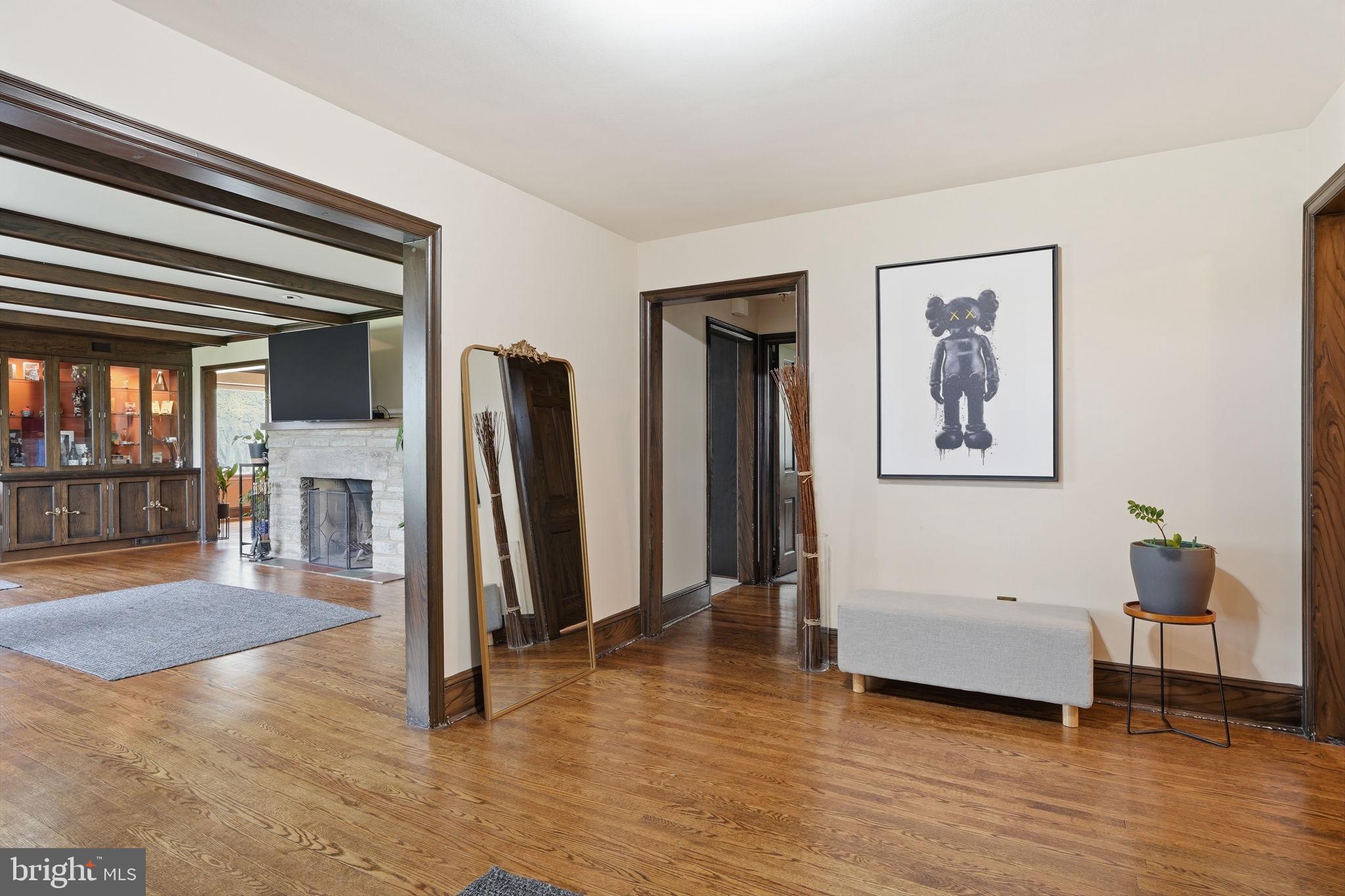 448 Moredon Road Huntingdon Valley, PA 19006 - Photo 7 of 66 a view of a livingroom with wooden floor and a flat screen tv