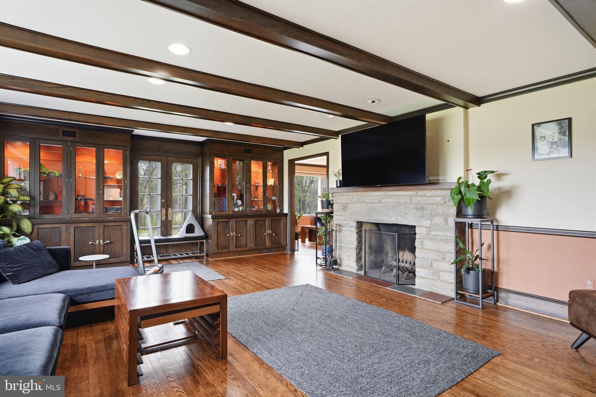 448 Moredon Road Huntingdon Valley, PA 19006 - Photo 9 of 66 a living room with furniture a fireplace and a flat screen tv