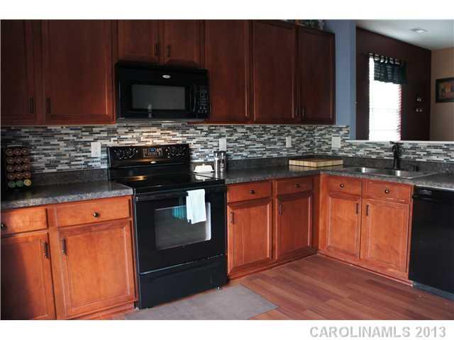 12017 Downy Birch Road Charlotte, NC 28227 - Photo 3 of 16 a kitchen with granite countertop stainless steel appliances and cabinets