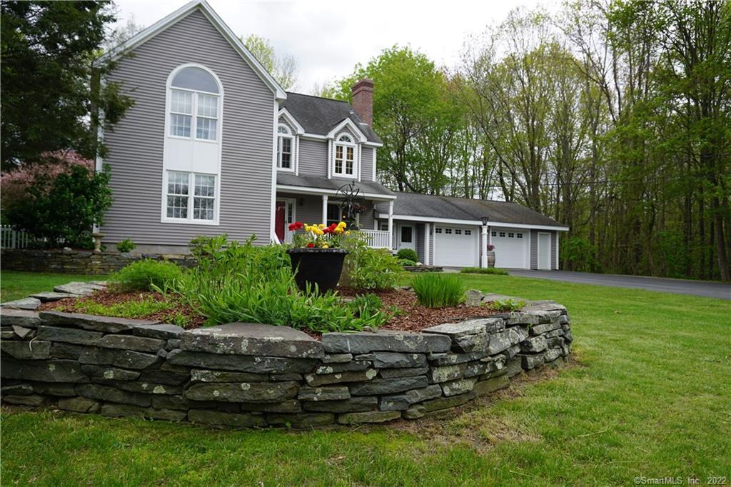 137 Dow Road Plainfield, CT 06374 - Photo 1 of 1 a front view of a house with a garden