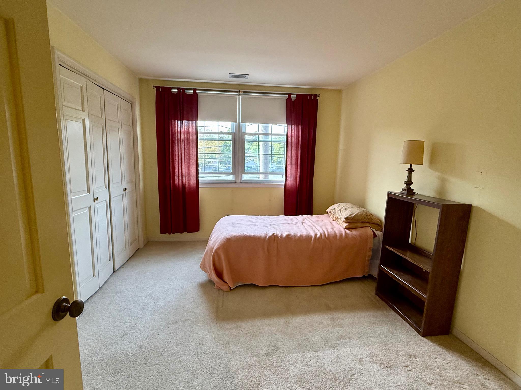 203 Haddonfield Commons Haddonfield, NJ 08033 - Photo 15 of 19 a spacious bedroom with a bed dresser and a window