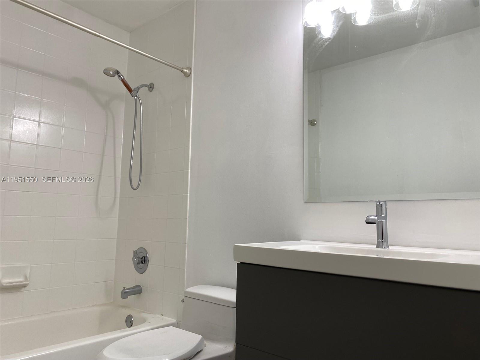 11301 Rockinghorse Road Cooper City, FL 33026 - Photo 12 of 34 a bathroom with a sink toilet vanity and shower