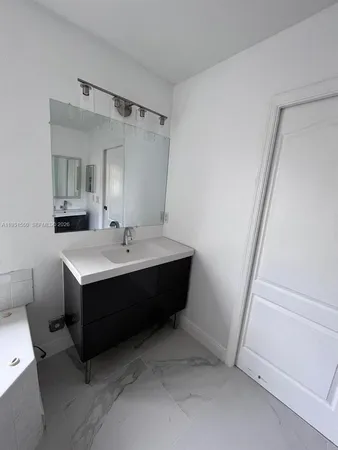 a room with a sink and a mirror
