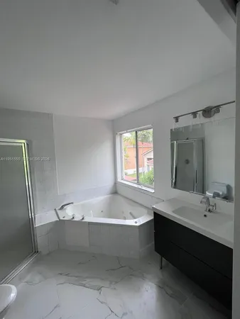 a bathroom with a sink vanity and mirror