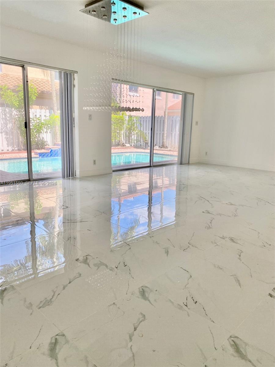 11301 Rockinghorse Road Cooper City, FL 33026 - Photo 3 of 34 an empty room with windows