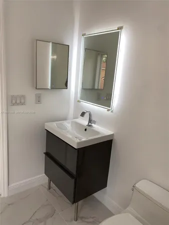 a bathroom with a sink vanity and a bathtub