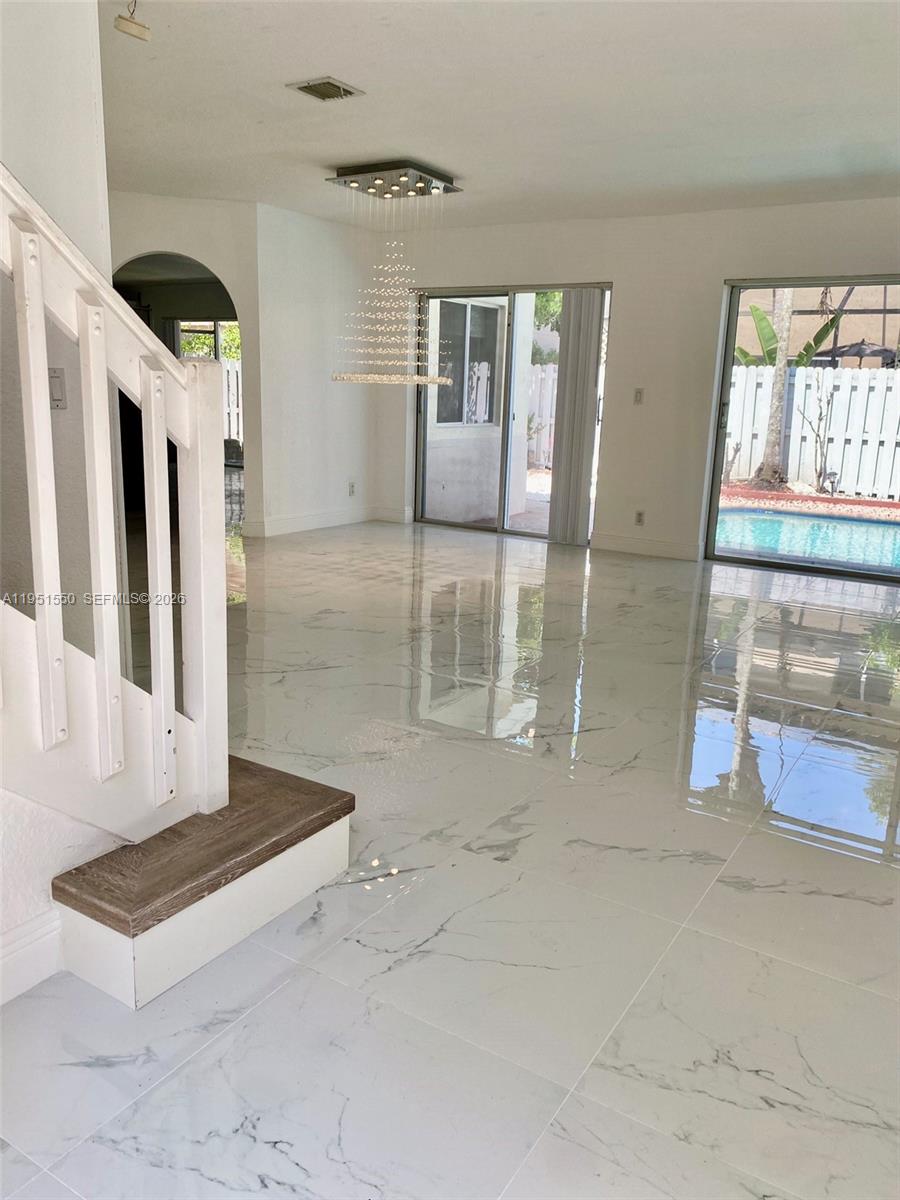 11301 Rockinghorse Road Cooper City, FL 33026 - Photo 5 of 34 a view of a hallway with entryway and window