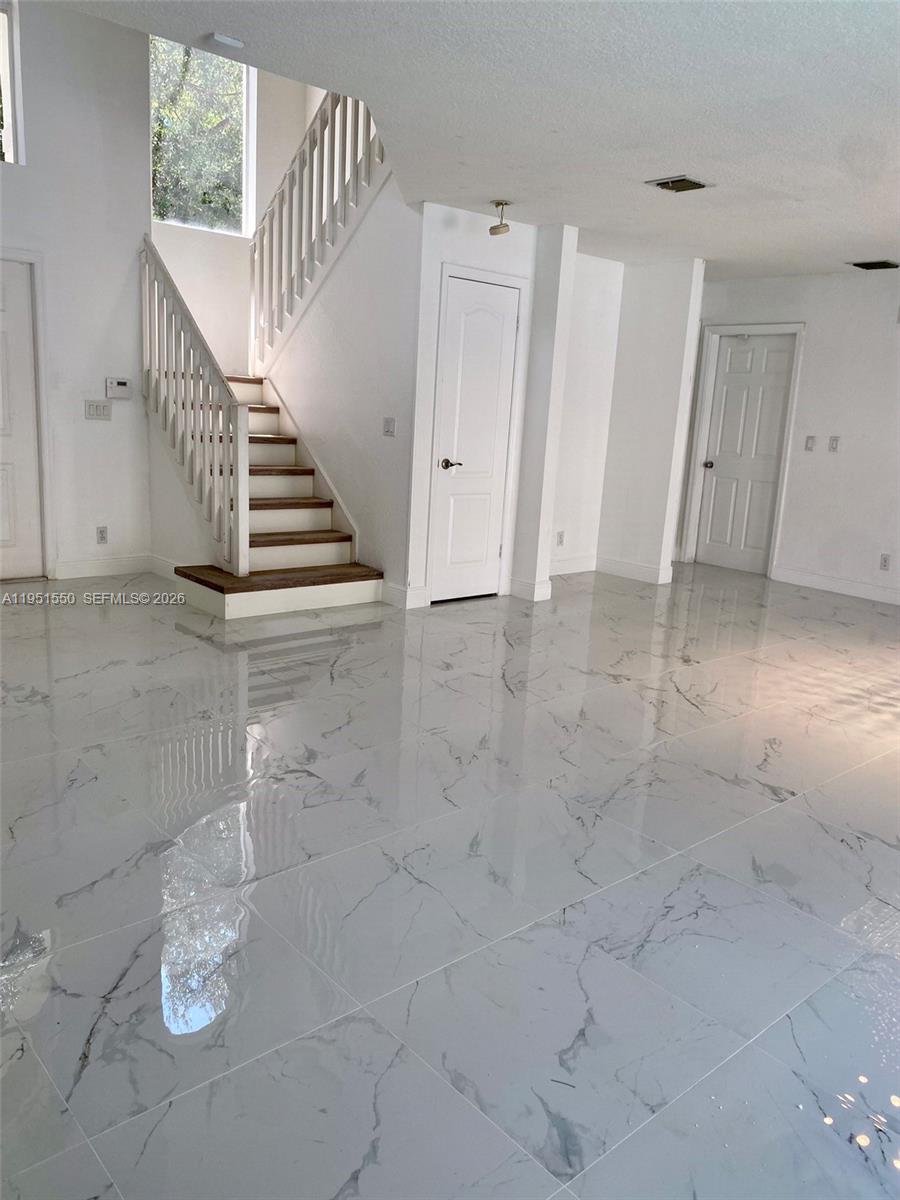 11301 Rockinghorse Road Cooper City, FL 33026 - Photo 7 of 34 a view of a livingroom with an empty space