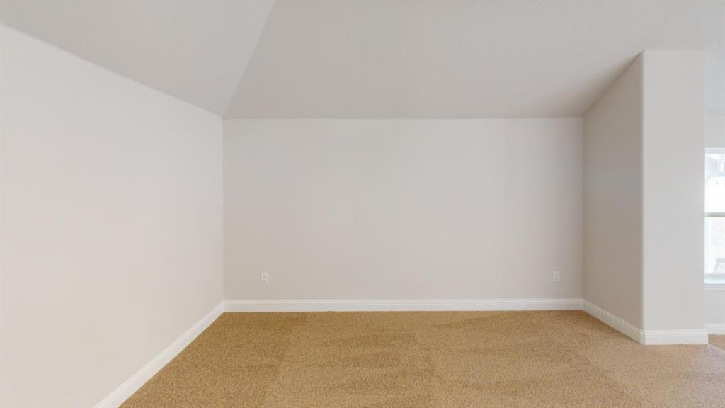 8407 Cornerstone Drive Rowlett, TX 75088 - Photo 11 of 25 Carpeted room featuring a neutral color palette, sloped ceiling, light-toned walls, white trim, and a window providing natural illumination