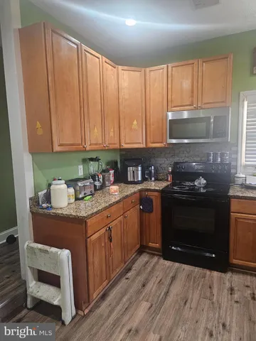 a kitchen with a stove a sink and a microwave