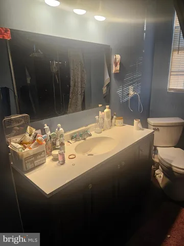 a bathroom with a sink toilet and a mirror
