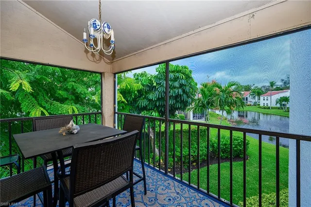 a view of a balcony with chairs and a table