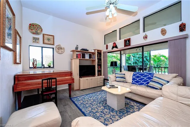 a living room with furniture a rug and a chandelier